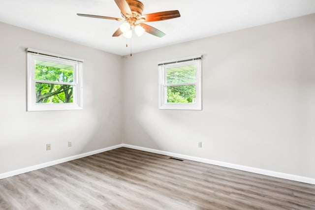 207 Hammitt Dr, Normal, IL 61761 - empty room featuring healthy amount of natural light, wood finished floors, and a ceiling fan