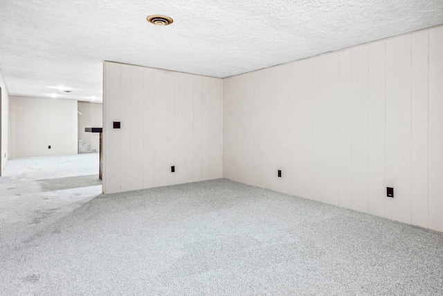 207 Hammitt Dr, Normal, IL 61761 - carpeted spare room with a textured ceiling and wood walls