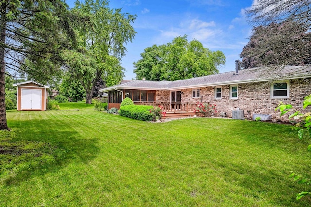 207 Hammitt Dr, Normal, IL 61761 - back of property featuring a shed, a sunroom, a yard, a deck, and brick siding