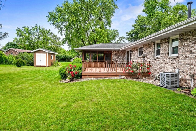 207 Hammitt Dr, Normal, IL 61761 - view of green lawn featuring a storage unit, a deck, and a sunroom