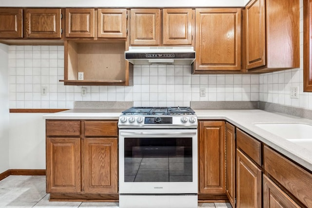 207 Hammitt Dr, Normal, IL 61761 - kitchen with stainless steel range with gas stovetop, under cabinet range hood, backsplash, and light countertops