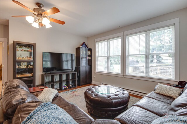 20760 N Florence Ave, Lincolnshire, IL 60069 - living area featuring healthy amount of natural light, baseboard heating, a ceiling fan, and wood finished floors