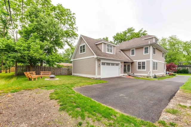 20760 N Florence Ave, Lincolnshire, IL 60069 - view of front of house with a fire pit, driveway, a shingled roof, and a garage