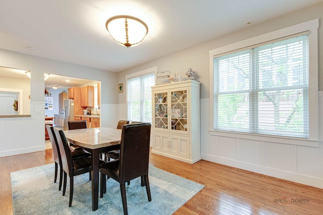 20760 N Florence Ave, Lincolnshire, IL 60069 - dining room featuring light wood-style floors, a wainscoted wall, and a decorative wall