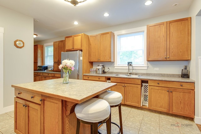 20760 N Florence Ave, Lincolnshire, IL 60069 - kitchen featuring freestanding refrigerator, light tile patterned floors, light countertops, a kitchen island, and recessed lighting