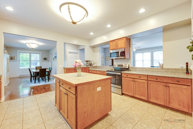20760 N Florence Ave, Lincolnshire, IL 60069 - kitchen with stainless steel appliances, light countertops, light tile patterned floors, a kitchen island, and recessed lighting