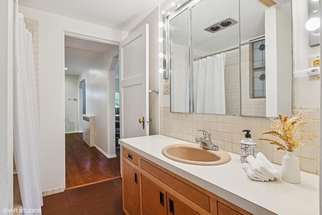 761 Revere Rd, Glen Ellyn, IL 60137 - bathroom featuring vanity, decorative backsplash, a shower with curtain, and wood finished floors