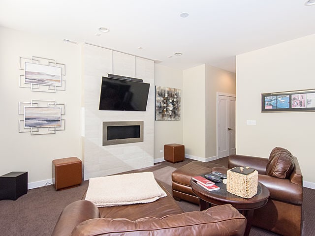 2036 W Huron St, Chicago, IL 60612 - carpeted living room featuring a tile fireplace and recessed lighting
