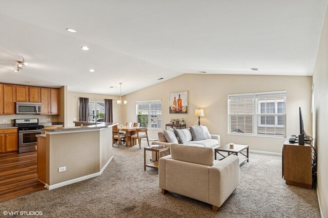 5113 Williston Ct Unit 0, Plainfield, IL 60586 - living area featuring dark carpet, lofted ceiling, a chandelier, and recessed lighting