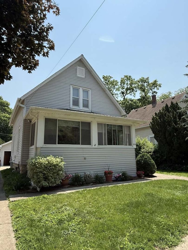 bungalow-style house featuring a front yard and a garage