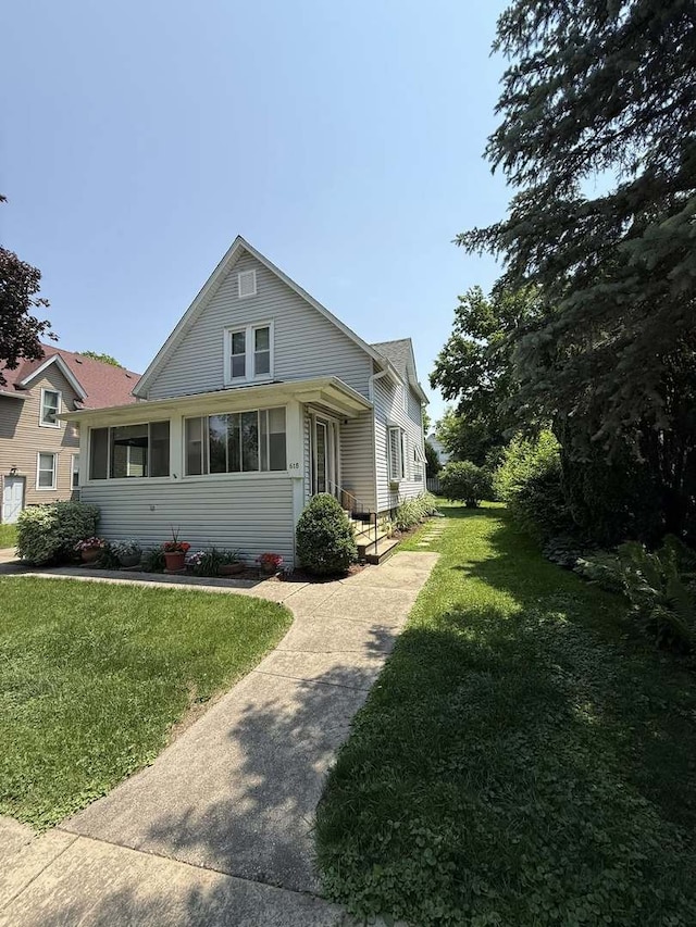 view of side of property with a yard
