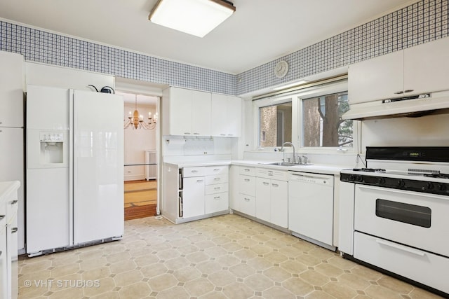 822 Clinton Pl, Evanston, IL 60201 - kitchen with white appliances, under cabinet range hood, a chandelier, white cabinetry, and light countertops