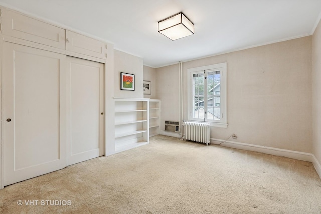 822 Clinton Pl, Evanston, IL 60201 - unfurnished bedroom with radiator, carpet, ornamental molding, and a closet