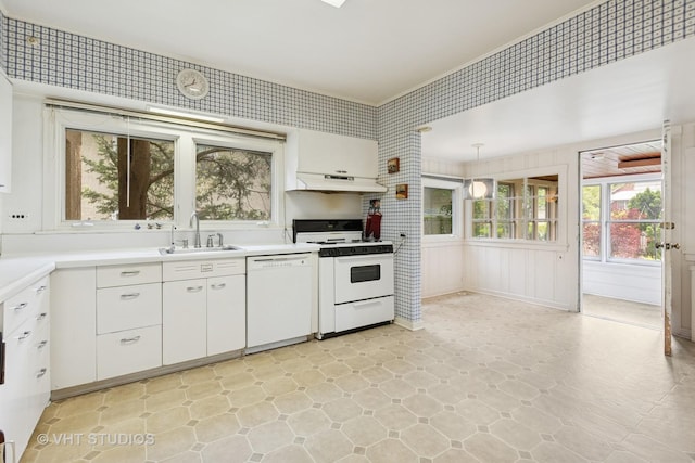 822 Clinton Pl, Evanston, IL 60201 - kitchen with white appliances, white cabinets, under cabinet range hood, light countertops, and hanging light fixtures