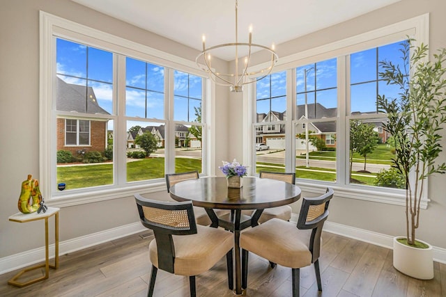17035 Clover Dr, Orland Park, IL 60467 - dining room featuring a chandelier, plenty of natural light, wood finished floors, and a residential view