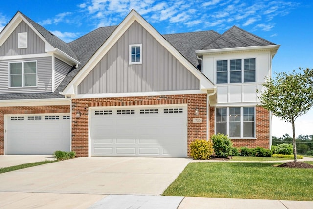 17035 Clover Dr, Orland Park, IL 60467 - view of front of house with board and batten siding, brick siding, driveway, an attached garage, and a shingled roof