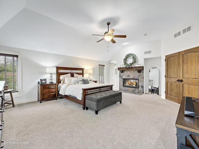 22 Yorkshire Woods, Oak Brook, IL 60523 - bedroom featuring vaulted ceiling, light carpet, ceiling fan, arched walkways, and a tiled fireplace