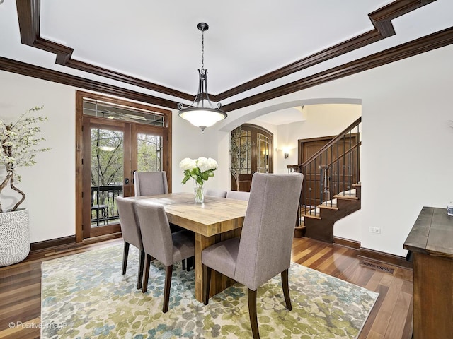 22 Yorkshire Woods, Oak Brook, IL 60523 - dining room featuring dark wood-style flooring, arched walkways, crown molding, and stairs