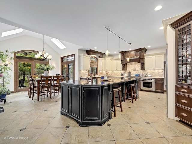 22 Yorkshire Woods, Oak Brook, IL 60523 - kitchen with oven, a skylight, a chandelier, decorative backsplash, and vaulted ceiling