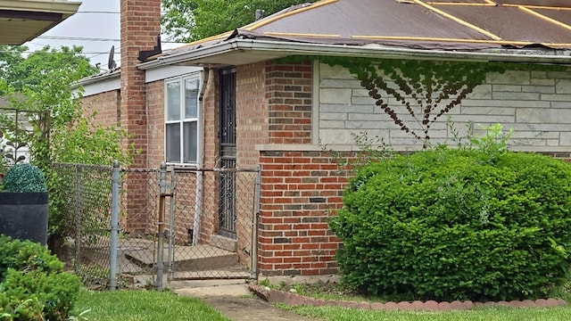9426 S Peoria St, Chicago, IL 60620 - view of home's exterior with a gate, brick siding, and a chimney