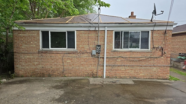 9426 S Peoria St, Chicago, IL 60620 - view of side of property featuring brick siding, a patio area, and a chimney