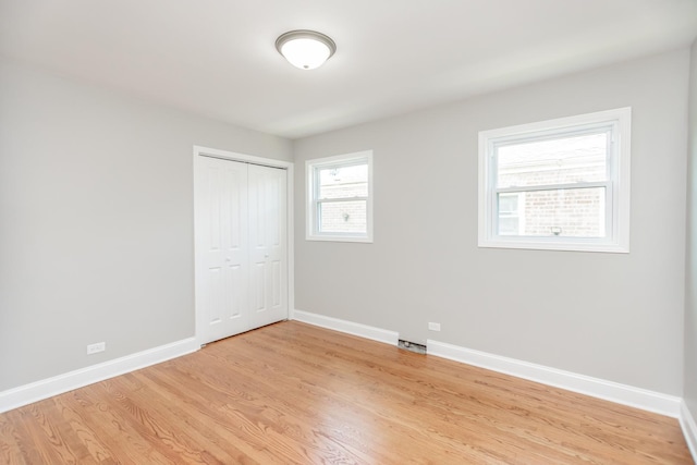 2101 W 82nd Pl, Chicago, IL 60620 - unfurnished bedroom with light wood-style flooring and a closet