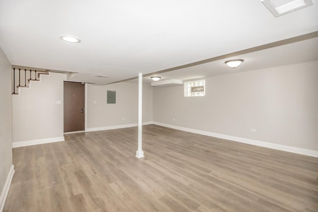 2101 W 82nd Pl, Chicago, IL 60620 - below grade area with electric panel, light wood-type flooring, and stairway