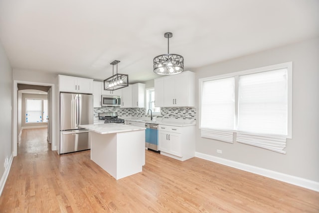 2101 W 82nd Pl, Chicago, IL 60620 - kitchen featuring stainless steel appliances, a kitchen island, white cabinets, and backsplash
