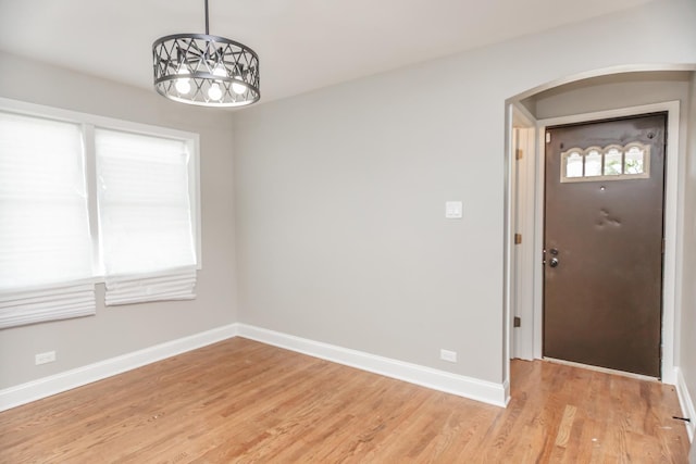 2101 W 82nd Pl, Chicago, IL 60620 - spare room with arched walkways, light wood-style flooring, and a chandelier