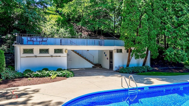 524 E Van Buren St, Ottawa, IL 61350 - view of front of home featuring stairs, stucco siding, a patio area, and an outdoor pool