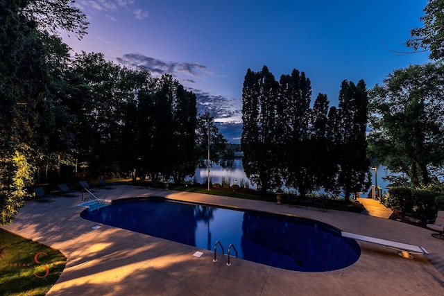 524 E Van Buren St, Ottawa, IL 61350 - pool at dusk with a patio, a diving board, and an outdoor pool