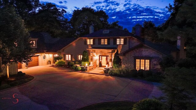 524 E Van Buren St, Ottawa, IL 61350 - view of front of home with concrete driveway, a garage, a chimney, and stone siding