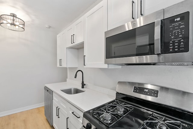 918 W Sunnyside Ave Unit 1B, Chicago, IL 60640 - kitchen featuring stainless steel appliances, white cabinets, and light countertops