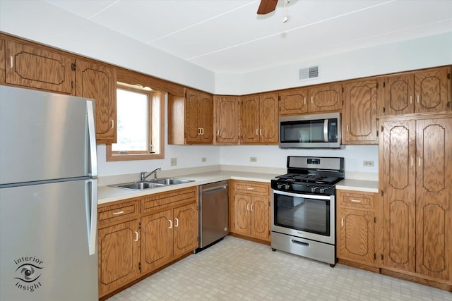 8838 W 140th St Unit 2D, Orland Park, IL 60462 - kitchen with appliances with stainless steel finishes, brown cabinets, light countertops, light flooring, and a ceiling fan
