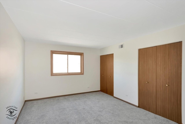 8838 W 140th St Unit 2D, Orland Park, IL 60462 - unfurnished bedroom featuring two closets and carpet floors