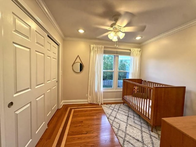 1860 Dorchester Ave, Algonquin, IL 60102 - bedroom featuring wood finished floors, ornamental molding, a crib, a closet, and a ceiling fan
