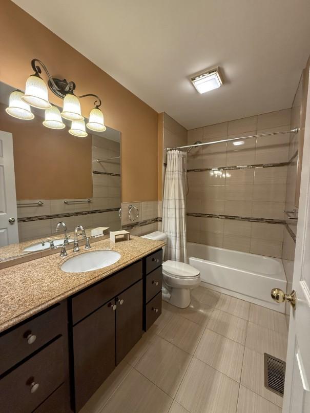 1860 Dorchester Ave, Algonquin, IL 60102 - bathroom featuring vanity, tile walls, shower / bathtub combination with curtain, and tile patterned floors