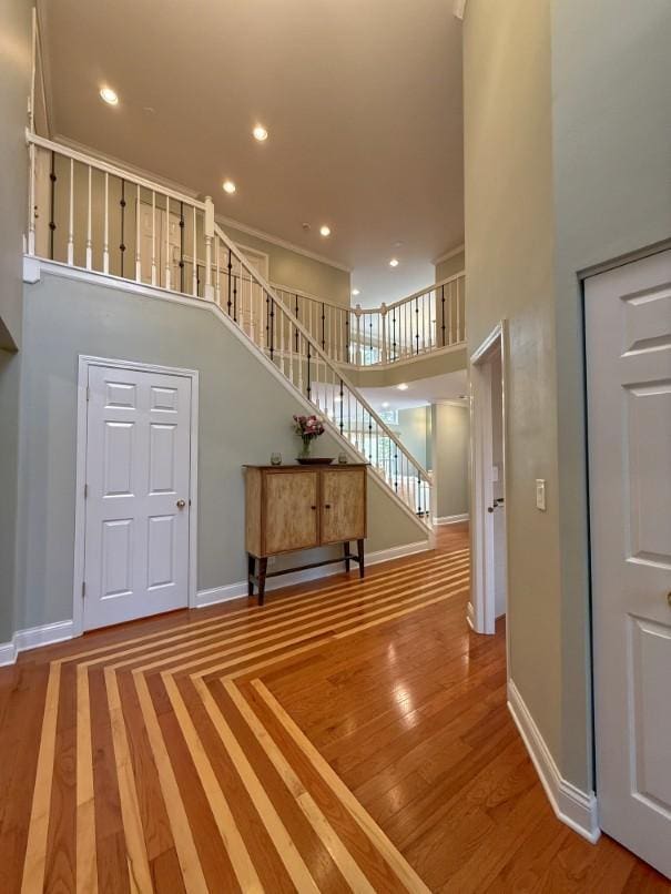 1860 Dorchester Ave, Algonquin, IL 60102 - unfurnished living room with stairs, a high ceiling, recessed lighting, and wood finished floors