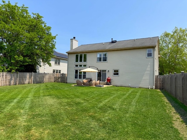 1860 Dorchester Ave, Algonquin, IL 60102 - back of house with a fenced backyard and a chimney