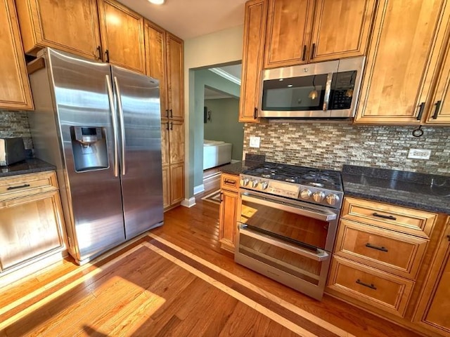 1860 Dorchester Ave, Algonquin, IL 60102 - kitchen with stainless steel appliances, wood finished floors, brown cabinetry, and tasteful backsplash