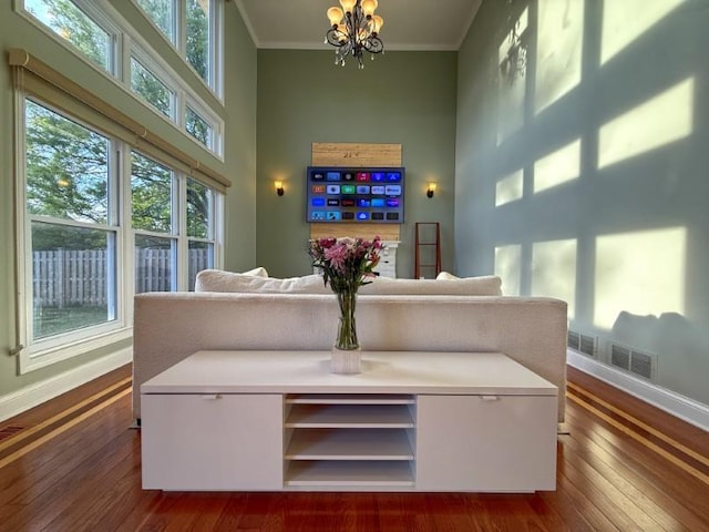 1860 Dorchester Ave, Algonquin, IL 60102 - living area with a high ceiling, ornamental molding, a chandelier, and dark wood-style flooring