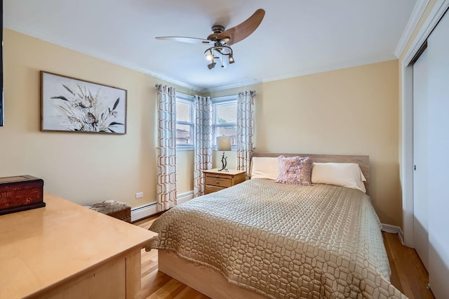 8712 W Berwyn Ave Unit 3W, Chicago, IL 60656 - bedroom with light wood finished floors, a closet, crown molding, a baseboard radiator, and a ceiling fan