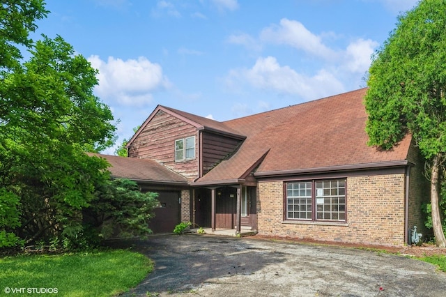 1940 Cypress Ln, Northbrook, IL 60062 - view of front of property with driveway, brick siding, covered porch, and roof with shingles
