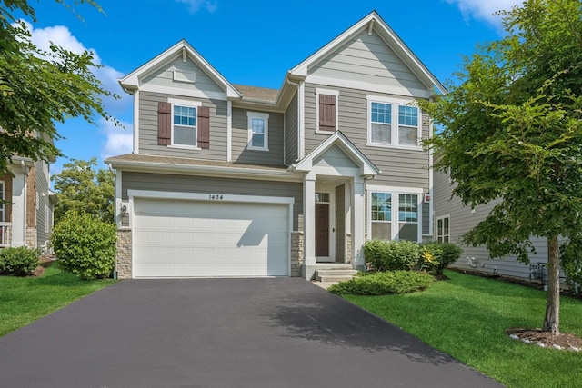 1434 Somerset Pl, Barrington, IL 60010 - view of front of house with asphalt driveway, a garage, a front yard, and stone siding