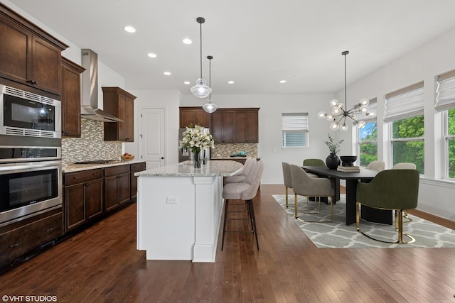 1434 Somerset Pl, Barrington, IL 60010 - kitchen featuring stainless steel appliances, wall chimney exhaust hood, dark brown cabinetry, tasteful backsplash, and recessed lighting
