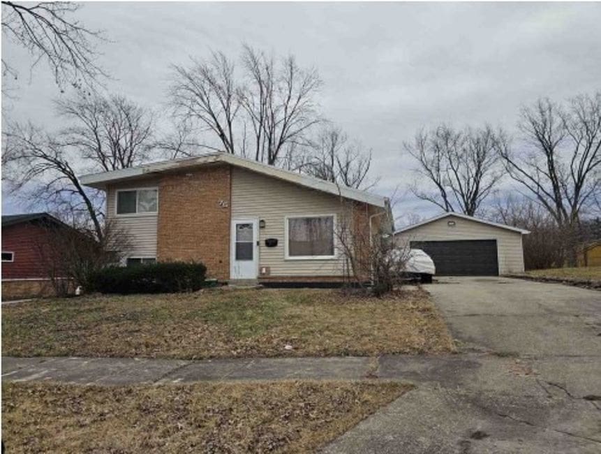 75 Water St, Park Forest, IL 60466 - view of front of house featuring a garage and an outbuilding