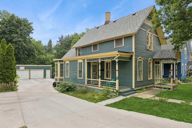 16 N Gifford St, Elgin, IL 60120 - victorian-style house with an outbuilding, covered porch, a chimney, roof with shingles, and a garage