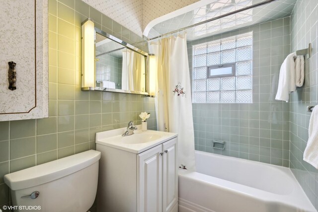 1609 Boeger Ave, Westchester, IL 60154 - bathroom with shower / bath combo, vanity, tile walls, and wallpapered walls