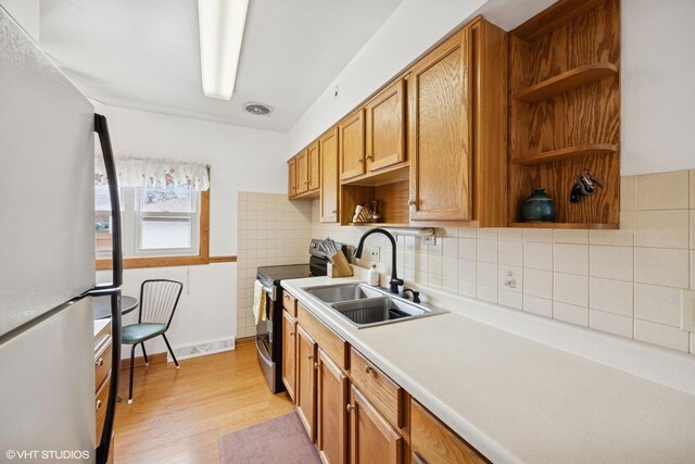 1609 Boeger Ave, Westchester, IL 60154 - kitchen with freestanding refrigerator, stainless steel electric stove, open shelves, and light wood finished floors