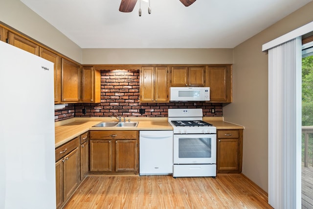 3112 Cedar Ter, Island Lake, IL 60042 - kitchen featuring white appliances, brown cabinets, light wood-style flooring, and light countertops